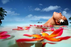 Close up view of an attractive young woman floating on a spa's swimming pool.